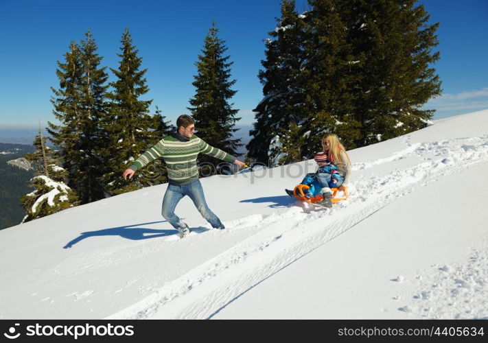 Winter season. Happy family having fun on fresh snow on vacation.