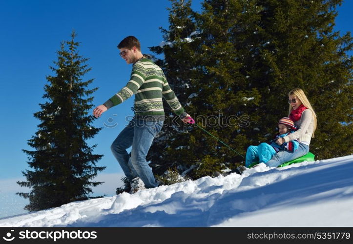 Winter season. Happy family having fun on fresh snow on vacation.