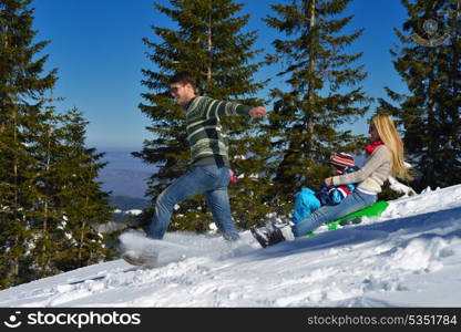 Winter season. Happy family having fun on fresh snow on vacation.