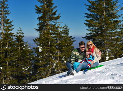 Winter season. Happy family having fun on fresh snow on vacation.