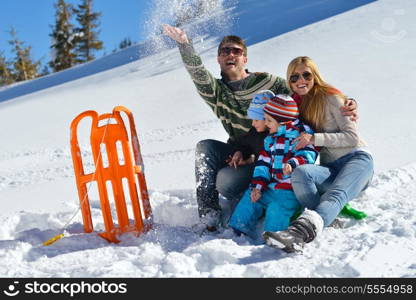 Winter season. Happy family having fun on fresh snow on vacation.