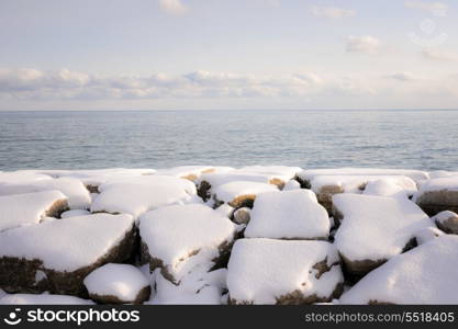 Winter shore of lake Ontario. Rocks under snow on winter shore of lake Ontario in Sylvan park Toronto