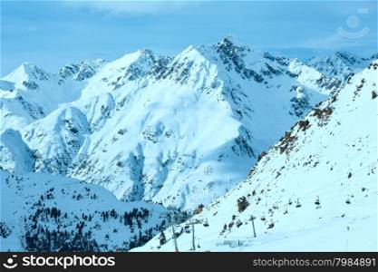 Winter Silvretta Alps landscape and ski lift on slope, Tyrol, Austria. All people are unrecognizable.