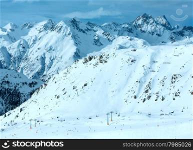 Winter Silvretta Alps landscape and ski lift on slope, Tyrol, Austria. All skiers are unrecognizable.