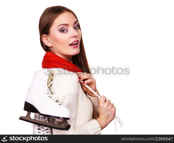 Winter skate sport people concept. Attractive girl with ice skates. Young woman has white outfit and long beutiful hair.. Attractive girl with ice skates.