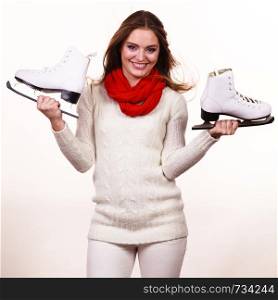 Winter skate sport people concept. Crazy girl with ice skates. Young woman has white outfit and long beutiful hair.. Crazy girl with ice skates.