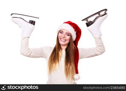 Winter skate sport people concept. Girl with santa claus cap. Young woman has white outfit and long beutiful hair, female holdingtwo ice skates.. Girl with santa claus cap.