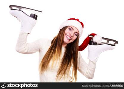Winter skate sport people concept. Girl with santa claus cap. Young woman has white outfit and long beutiful hair, female holdingtwo ice skates.. Girl with santa claus cap.