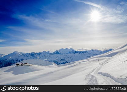 Winter snow covered mountain peaks in Europe. The Alps winter mountain landscape
