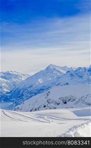 Winter snow covered mountain peaks in Europe. The Alps winter mountain landscape
