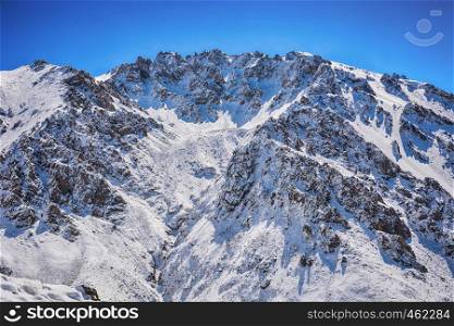 Winter snow covered mountain peaks. Tourists Ala-Archa National Park in Kyrgyzstan.
