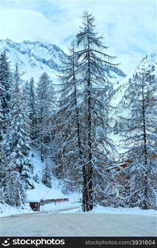 Winter snowy peaceful Samnaun Alps landscape and country road with barrier (Swiss).
