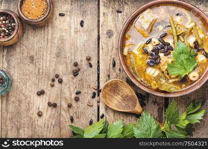 Winter soup with meat and black beans.Copy space. Bowl of delicious meat soup