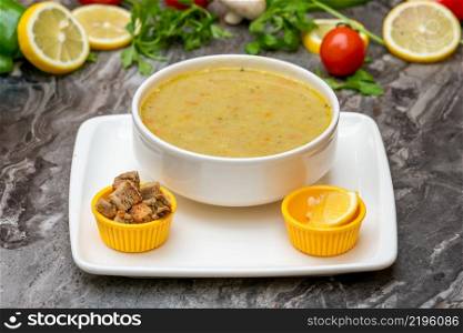 Winter soup with vegetables in a white porcelain bowl
