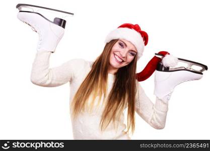 Winter sport activity. Young woman with ice skates getting ready for ice skating,. Smiling cheerful girl wearing santa claus hat on white. woman santa claus with ice skates
