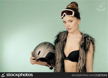 Winter, sport, fashion concept. Amazing female holding helmet.. Amazing female holding helmet.