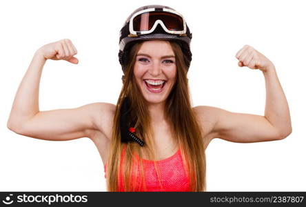 Winter sport people concept. Strong woman with sporty helmet. Young lady wearing red clothing showing her biceps muscles. Strong woman with sporty helmet.