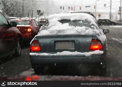 Winter storm, cars on the road while the snow falls.