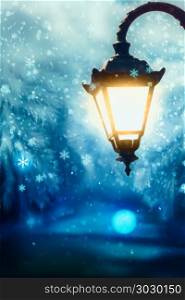 Winter Street Lamp. Lit up street lamp at snowy winter night close up, photo manipulation.