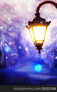 Winter Street Lamp. Lit up street lamp at snowy winter night close up, photo manipulation.