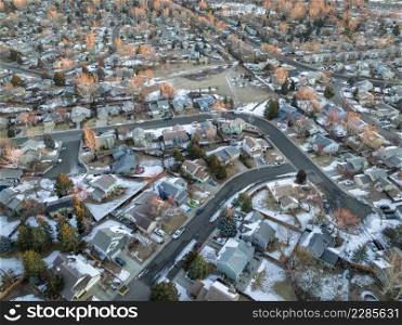 winter sunrise over residential area of Fort Collins in northern Colorado with some snow, aerial view