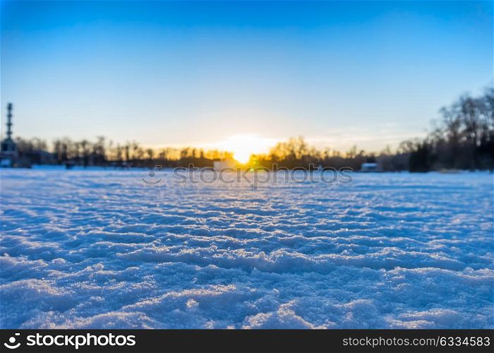 Winter sunset landscape with blurred background, focus on snow surface.. Winter sunset landscape background.