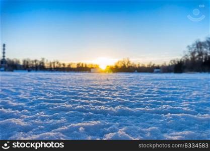Winter sunset landscape with blurred background, focus on snow surface.. Winter sunset landscape background.