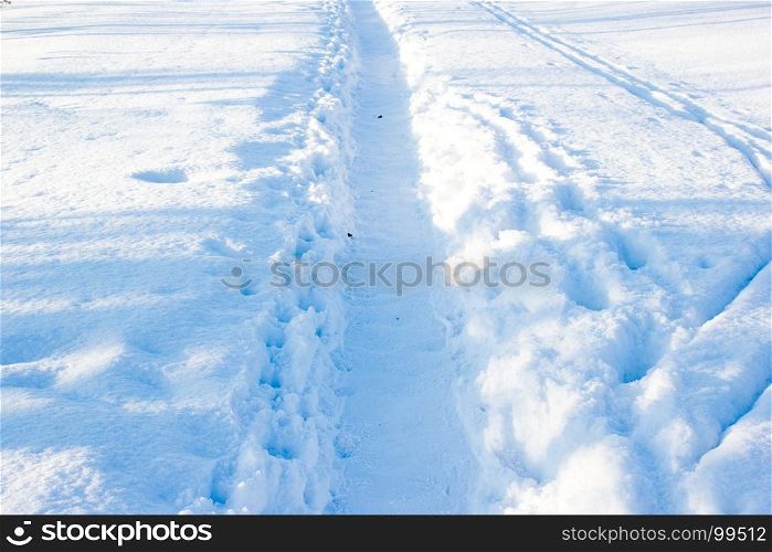 Winter trail, the road in the snow