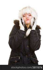 Winter vacation. Cheerful positive girl in warm clothes. Happy young woman in fur hat blowing a kiss isolated on white.