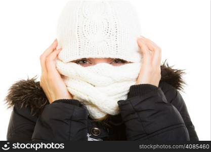 Winter vacation. Girl in warm clothes. Young woman covering her face with scarf hat from cold isolated on white.