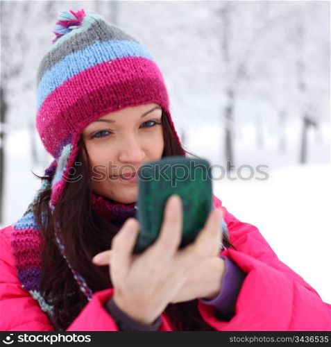 winter woman looking in mirror