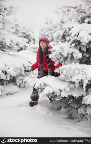 winter woman play snowballs on snow background