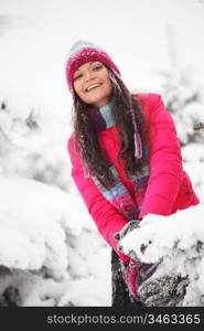 winter woman play snowballs on snow background