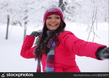 winter woman play snowballs on snow background