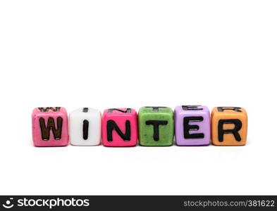 winter - word made from multicolored child toy cubes with letters