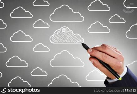 Wireless connection. Close up of male hand drawing cloud computing concept