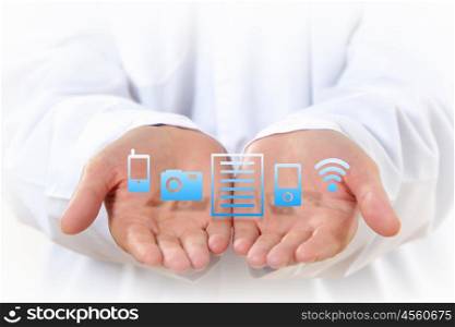 Wireless technologies. Close up of human hands with device icons