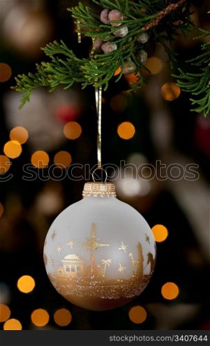Wise men xmas ornament in front of out of focus christmas tree