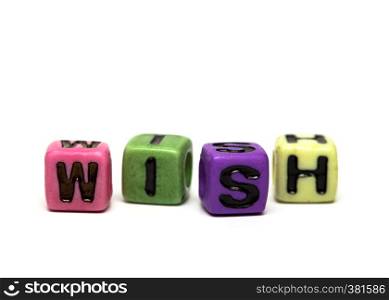 wish - word made from multicolored child toy cubes with letters