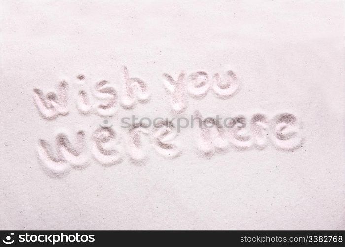 Wish you were here written in luxerious white sand