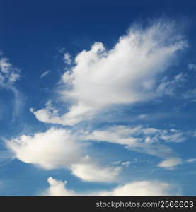 Wispy cloud formations against clear blue sky.