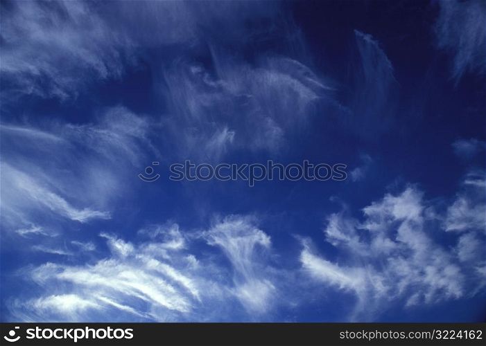 Wispy Clouds In A Deep Blue Sky