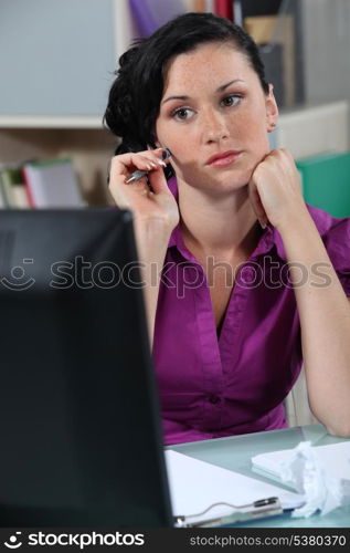 Wistful woman at a desk