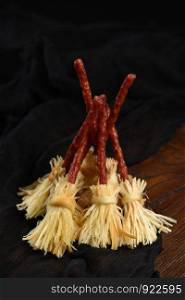 Witches Broom of smoked cheese suluguni and salami. Original idea Halloween snack.