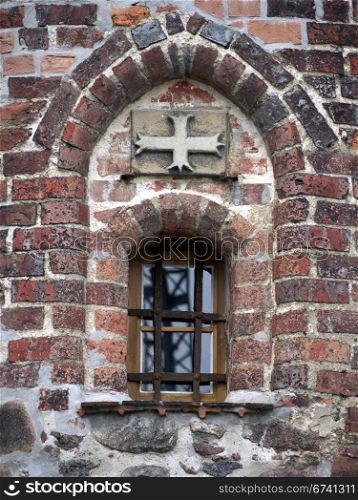 Witches Tower in Burg-detail. Window and cross in the witches tower in Burg, near Magdeburg