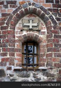 Witches Tower in Burg-detail. Window and cross in the witches tower in Burg, near Magdeburg