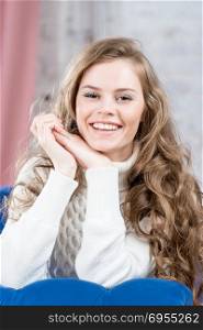 with a beautiful smile girl in a warm sweater vertical portrait