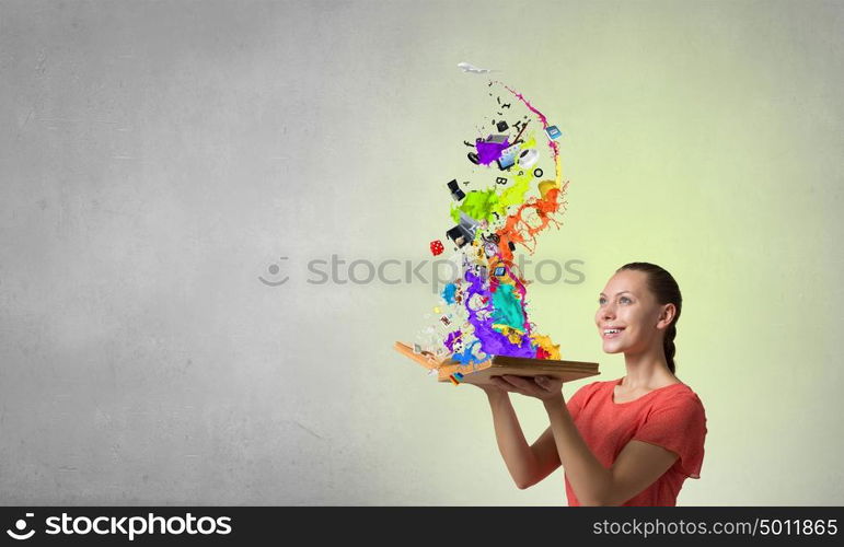 With books your imagination running wild. Young emotional woman in red dress with book in hands