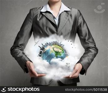 With care and love to our planet. Close view of businesswoman holding Earth planet in hands. Elements of this image are furnished by NASA