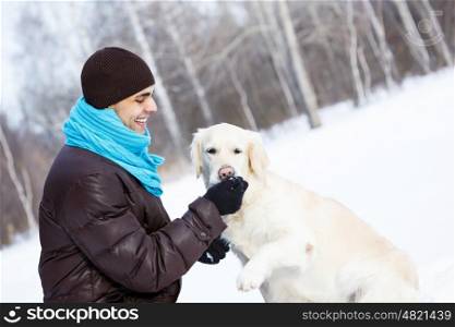 With his best friend. Guy with labrador dog on walk in winter park